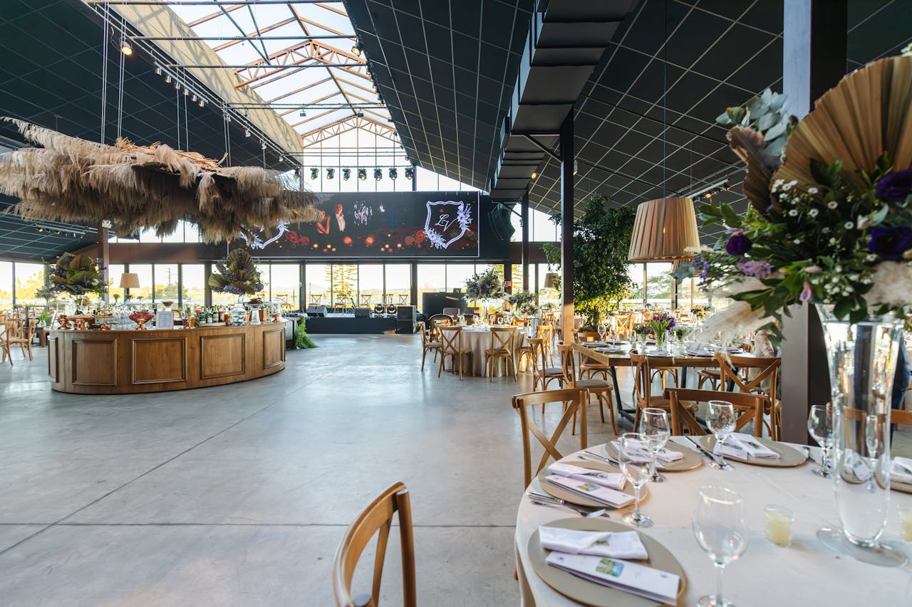 A spacious and elegant wedding venue with modern decor and ample seating, ideal for receptions.